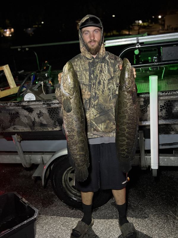 Shooter with a heavy snakehead beside the boat