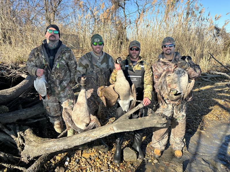 Hunting party with a strap of Canada geese
