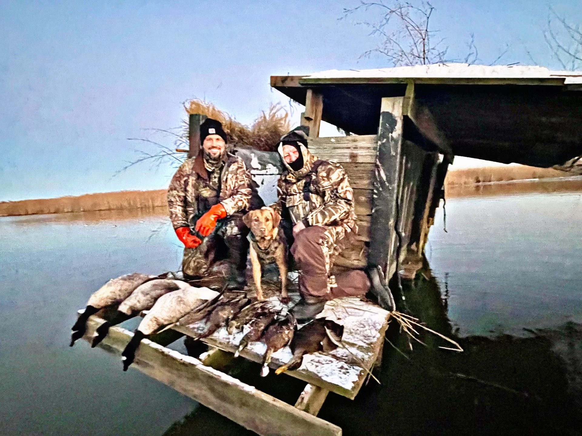Hunters working a blind on the edge of a Chesapeake marsh